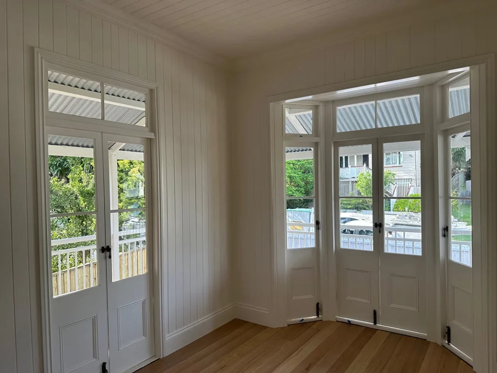 Interior of a room with white walls and wooden floors, recently repainted in Annerley by BJC Painters